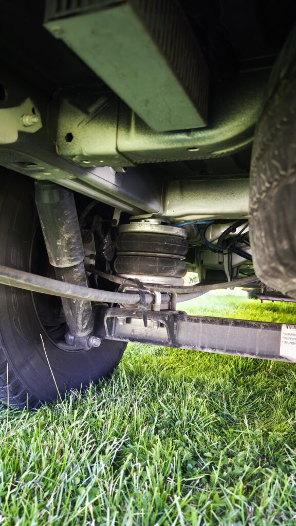 Obrázek zobrazuje podvozek obytného auta, který přehledně ukazuje části systému odpružení.