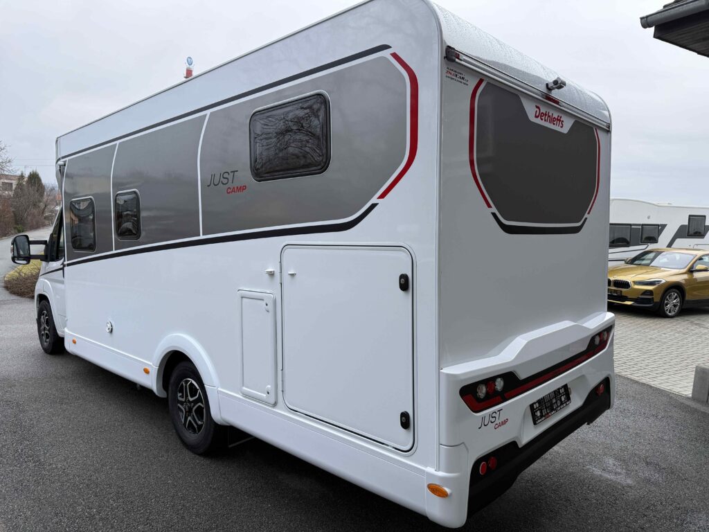 Obytné auto Dethleffs Just Camp na parkovišti, moderní design a prostorný interiér. Ideální pro cestování!